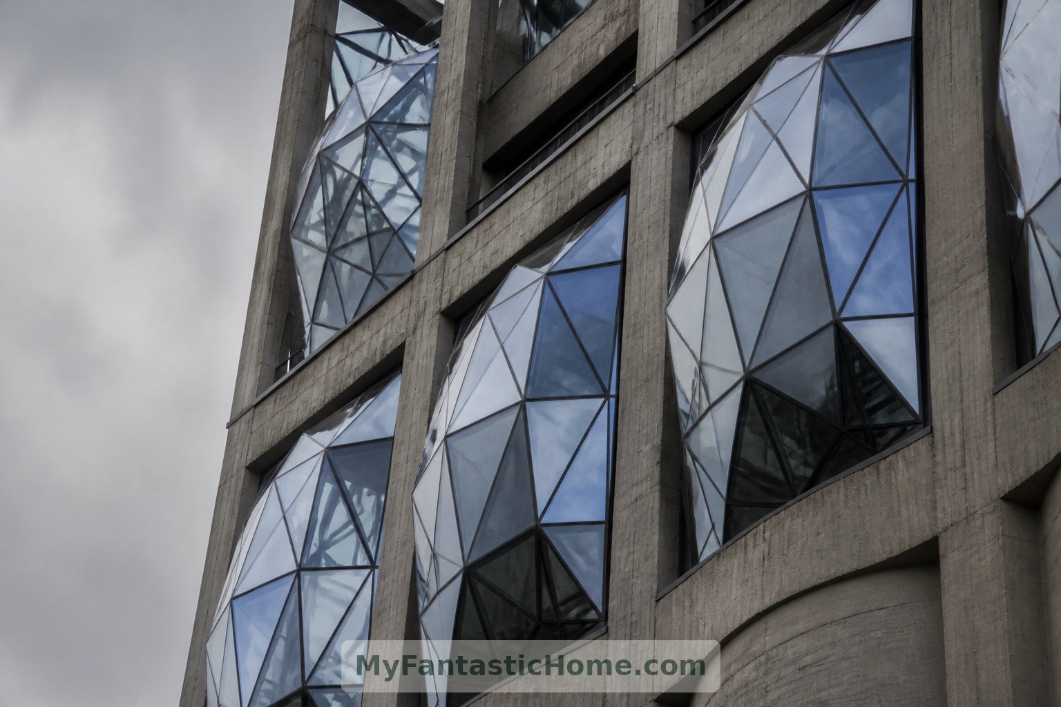 The Silo Hotel’s projecting, faceted windows create a striking contrast with the building’s industrial structure.